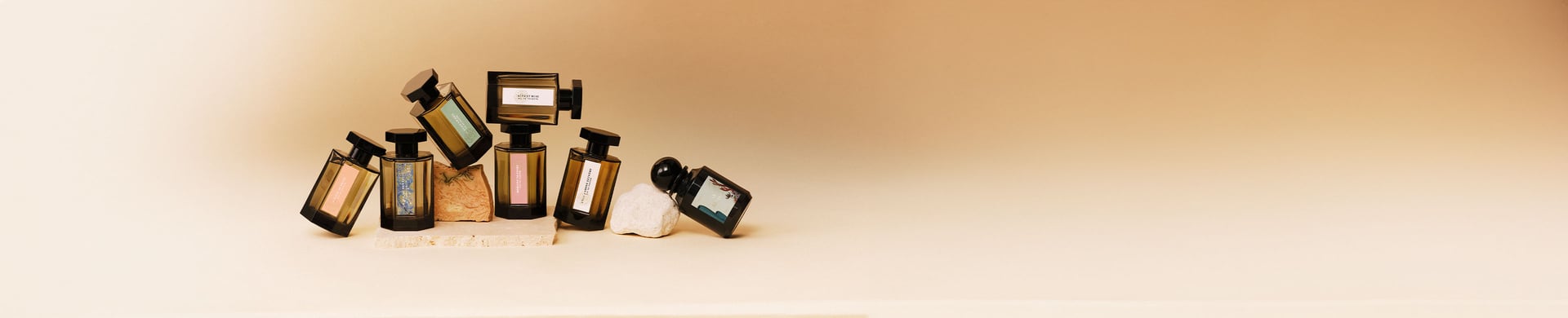Perfume bottles balanced on marble slabs on a beige background.jpg