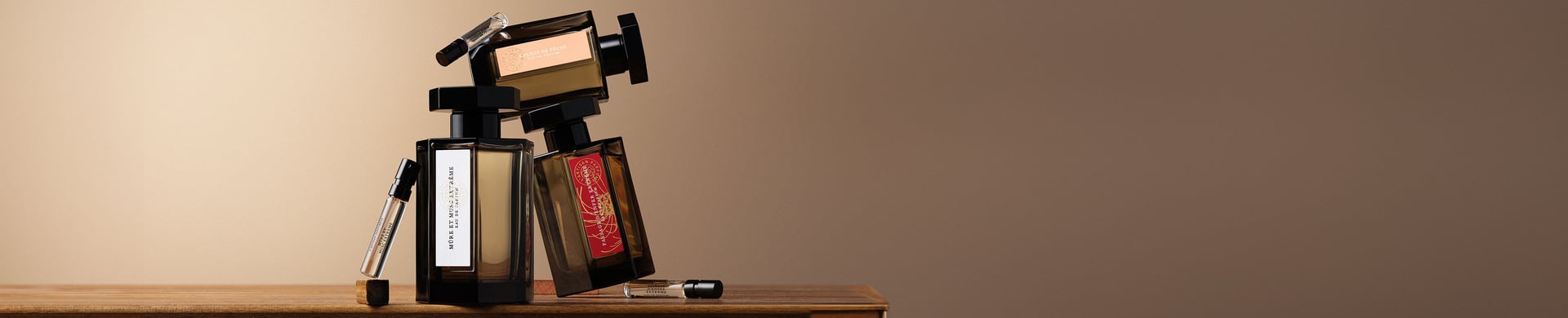Miniature perfume bottles on a wooden table with a brown background.jpg