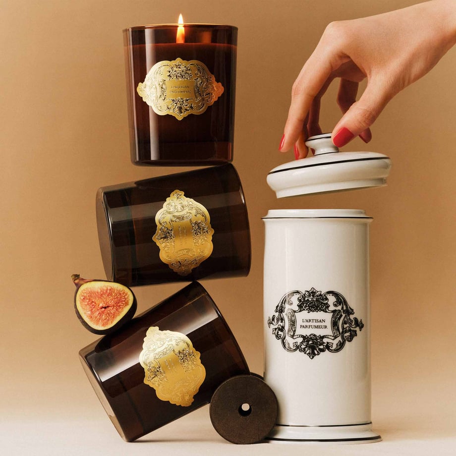 Three candles stacked on a beige background